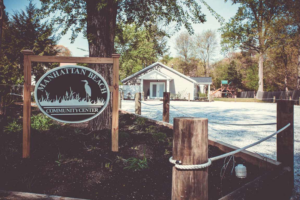 A view of the community sign and clubhouse